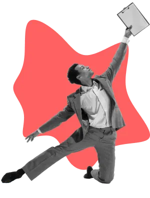 A suited man stands holding a piece of paper, appearing professional and engaged.